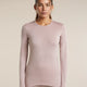 A woman modeling a long-sleeve crewneck top in a dusty mauve-pink color, paired with matching leggings, against a solid light beige background. - Icebreaker Merino 260 Oasis Long Sleeve Crew Thermal Top (Women's) - Pink Quartz