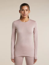 A woman modeling a long-sleeve crewneck top in a dusty mauve-pink color, paired with matching leggings, against a solid light beige background. - Icebreaker Merino 260 Oasis Long Sleeve Crew Thermal Top (Women's) - Pink Quartz