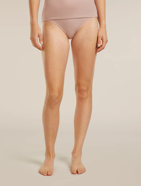 Person wearing a light pink high-waisted bikini bottom on a beige background - Icebreaker Merino 150 Siren Hipkini (Women's) - Pink Quartz