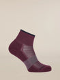 A single low-cut athletic sock in a deep burgundy color with a dark navy blue ribbed cuff and toe, featuring a textured knit pattern on the foot, shown against a solid light beige background. - Icebreaker Merino Multisport Light Mini Socks (Women's) - Dark Berry/Midnight Navy/Grey Plum