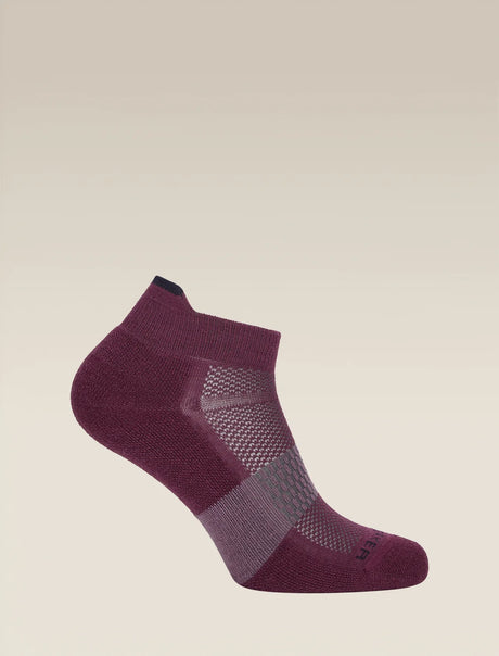 A single low-cut ankle sock in a deep plum purple color, featuring a textured knit pattern and a breathable mesh panel on the side, shown against a solid light beige background. - Icebreaker Merino Multisport Light Micro Socks (Women's) - Dark Berry/Midnight Navy/Grey Plum