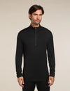 Man wearing a black long-sleeve shirt with a quarter zip on a beige background - Icebreaker Merino 260 Tech Long Sleeve Half Zip (Men's) - Black