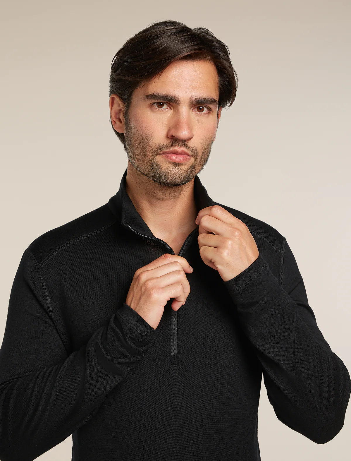 Man wearing a black pullover against a neutral background - Icebreaker Merino 260 Tech Long Sleeve Half Zip (Men's) - Black