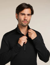 Man wearing a black pullover against a neutral background - Icebreaker Merino 260 Tech Long Sleeve Half Zip (Men's) - Black