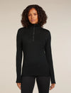 Woman wearing a black long-sleeve top with a quarter zip on a beige background - Icebreaker Merino 260 Tech Long Sleeve Half Zip Thermal Top (Women's) - Black