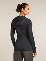 Woman wearing a dark gray hoodie and pants on a beige background - Icebreaker Merino Blend 200 Realfleece Descender Long Sleeve Zip Hoodie (Women's) - Jet Heather/Black