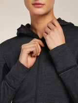Person wearing a dark gray hoodie with a neutral background - Icebreaker Merino Blend 200 Realfleece Descender Long Sleeve Zip Hoodie (Women's) - Jet Heather/Black