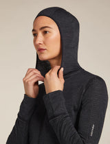 Person wearing a dark gray hooded jacket with a visible brand logo on a beige background - Icebreaker Merino Blend 200 Realfleece Descender Long Sleeve Zip Hoodie (Women's) - Jet Heather/Black