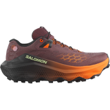 A Salomon trail running shoe in a dark plum-brown colorway with bright orange accents on the midsole, laces, and logo details, shown from a side profile on a white background. - Salomon Ultra Glide 4 Shoes (Women's) - Huckleberry/Black/Red Orange