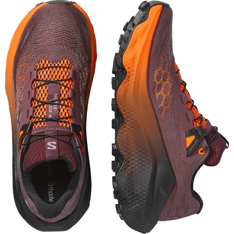 A pair of Salomon trail running shoes shown from the front and side on a clean white background. The shoes feature a dark plum-purple mesh upper with bright orange accents, a black and orange gradient midsole, and a rugged black outsole. - Salomon Ultra Glide 4 Shoes (Women's) - Huckleberry/Black/Red Orange