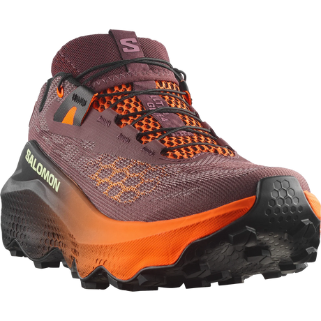 Salomon trail running shoe in a dark plum purple and bright orange colorway, featuring a textured knit upper, orange laces, and a thick orange and black midsole. - Salomon Ultra Glide 4 Shoes (Women's) - Huckleberry/Black/Red Orange