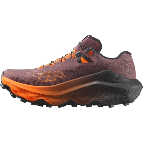 A trail running shoe in a dark plum-brown mesh upper with bright orange accents, a thick black and orange midsole, and a rugged black outsole, shown from a side profile on a white background. - Salomon Ultra Glide 4 Shoes (Women's) - Huckleberry/Black/Red Orange
