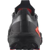Close-up rear view of a black athletic shoe with red accents and a textured sole, shown on a white background. - Salomon S/LAB Genesis 2 Shoes (Unisex) - Black/Black/Fiery Red