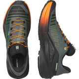 Salomon Genesis 2 running shoes shown from the top and side views on a white background. The shoes feature a dark gray and black mesh upper with vibrant orange accents on the laces, outsole, and heel. - Salomon Genesis 2 Shoes (Men's) - Urban Chic/Black/Lime Cream