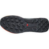 The bottom sole of a Salomon trail running shoe, showing a black textured tread pattern with a small red Salomon logo and a hint of orange on the heel edge, set against a plain white background. - Salomon Genesis 2 Shoes (Men's) - Urban Chic/Black/Lime Cream