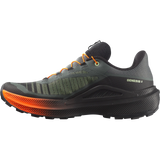 A single trail running shoe shown in a side profile view against a solid white background. The shoe features a dark gray and black upper with textured mesh panels, bright orange laces, and a thick black midsole with a vibrant orange gradient along the outsole. - Salomon Genesis 2 Shoes (Men's) - Urban Chic/Black/Lime Cream