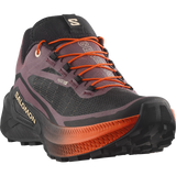 Salomon Genuine GTS hiking boot in dark gray and black with vibrant orange laces and midsole accents, shown from a three-quarters angle on a white background. - Salomon Genesis 2 Shoes (Women's) - Huckleberry/Black/Red Orange
