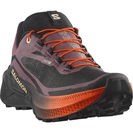 Salomon Genuine GTS hiking boot in dark gray and black with vibrant orange laces and midsole accents, shown from a three-quarters angle on a white background. - Salomon Genesis 2 Shoes (Women's) - Huckleberry/Black/Red Orange