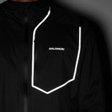 Close-up of a black Salomon jacket with a white reflective-looking outline around the chest pocket and a white Salomon logo on the chest. - Salomon Bonatti Pro Jacket (Men's) - Deep Black
