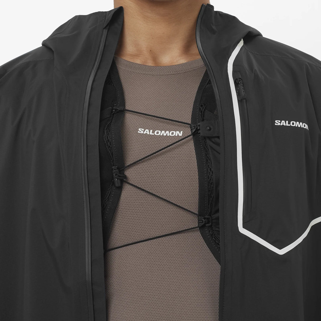 Black Salomon jacket with a person wearing a brown shirt underneath on a white background - Salomon Bonatti Pro Jacket (Men's) - Deep Black