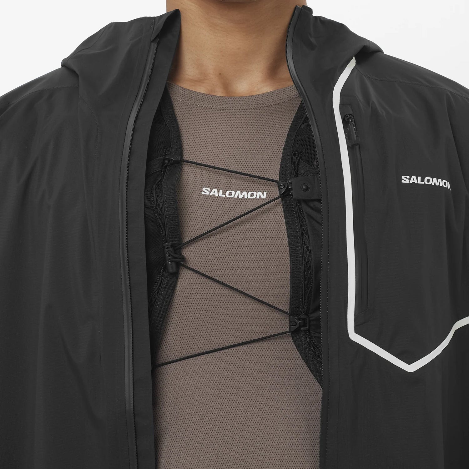 Black Salomon jacket with a person wearing a brown shirt underneath on a white background - Salomon Bonatti Pro Jacket (Men's) - Deep Black