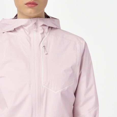 A close-up of a person wearing a light pink hooded jacket with a front zipper and a zippered chest pocket. The brand name 'balmy' is subtly printed in white on the chest pocket. - Salomon Bonatti Pro Jacket (Women's) - Icy Pink