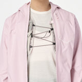 Person wearing a light pink jacket over a white shirt with a graphic design. - Salomon Bonatti Pro Jacket (Women's) - Icy Pink