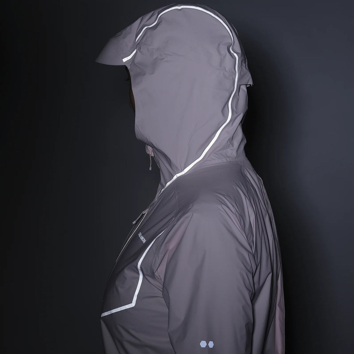 Gray raincoat with reflective accents on a black background - Salomon Bonatti Pro Jacket (Women's) - Icy Pink