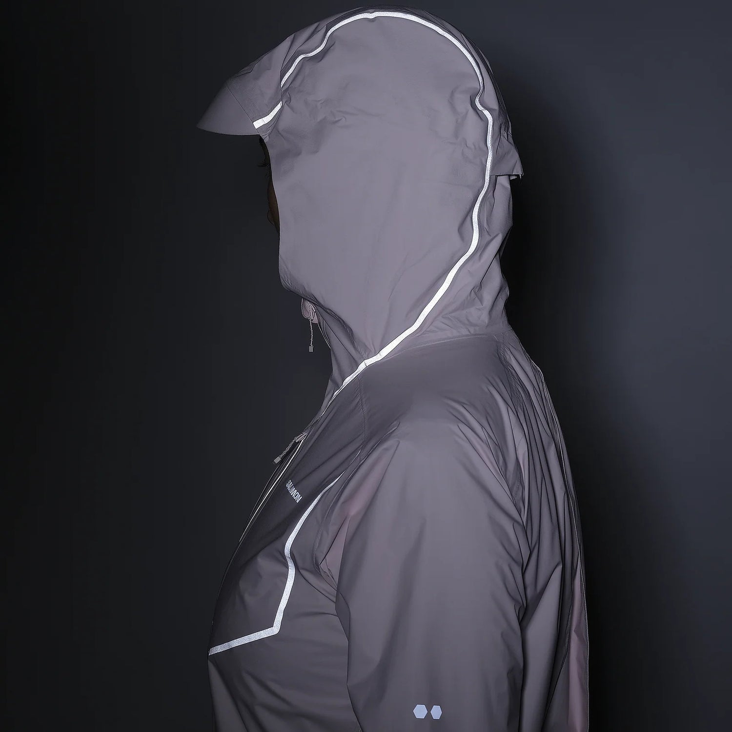 Gray raincoat with reflective accents on a black background - Salomon Bonatti Pro Jacket (Women's) - Icy Pink