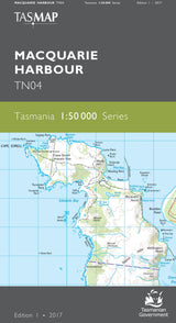 Front cover of a TASMAP Macquarie Harbour TN04 map publication, showing a light blue and green map of the harbour with place names and grid lines on a dark gray background. - Tasmap 1:50000 Topographic/Cadastral Maps - Macquarie Harbour