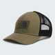 A trucker-style baseball cap by The North Face, featuring an olive green front panel and visor with a black mesh back, shown on a light gray background. - The North Face Mudder Trucker - Caraway Seed