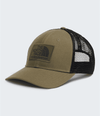A trucker-style baseball cap by The North Face, featuring an olive green front panel and visor with a black mesh back, shown on a light gray background. - The North Face Mudder Trucker - Caraway Seed