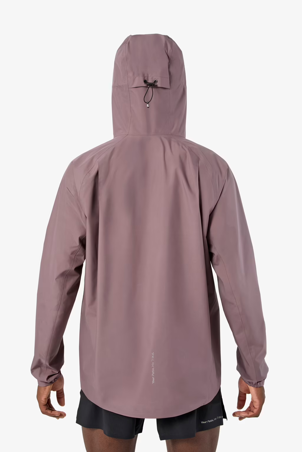A person shown from the back wearing a hooded athletic jacket in a muted dusty mauve color, paired with black shorts, against a clean light gray studio background. - NNormal Trail Rain Jacket 02 (Men's) - Purple