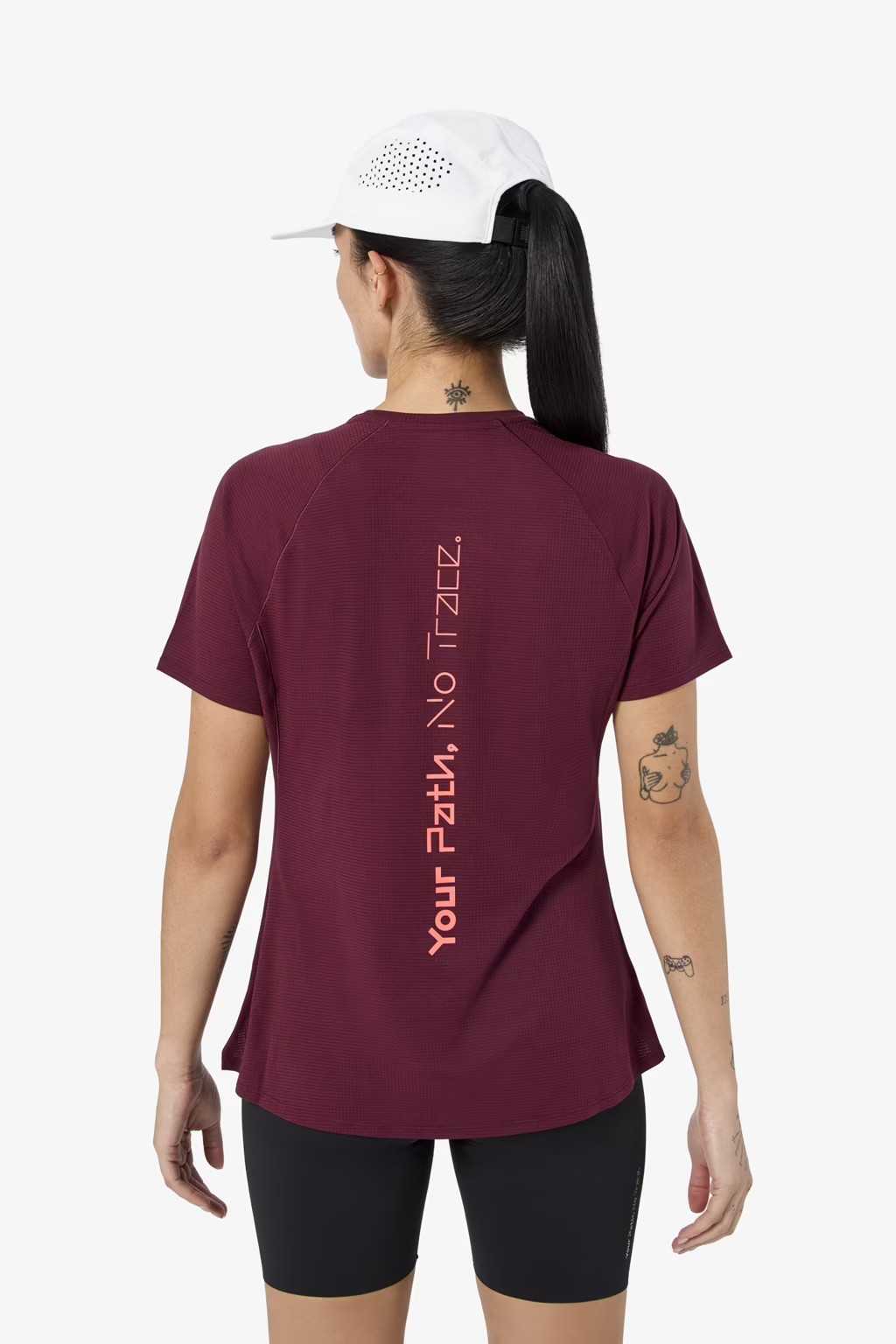 Person wearing a maroon t-shirt with text on the back, standing against a white background - NNormal Race T-Shirt 02 (Women's) - Burgundy