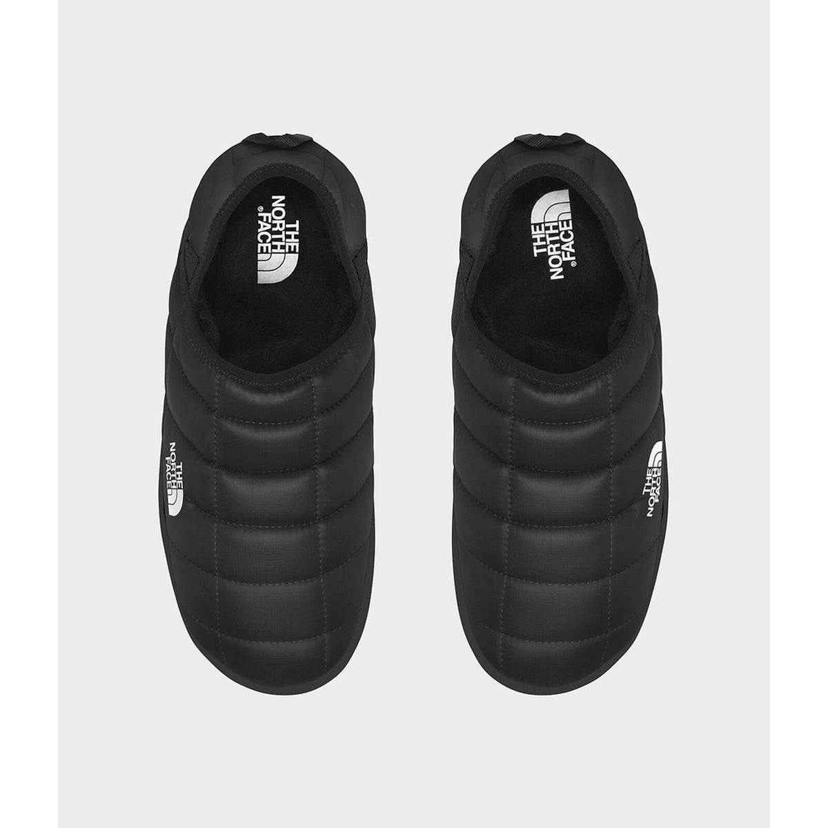 Black slip-on shoes with The North Face logo on a white background - The North Face ThermoBall Traction V Mules (Men's) - TNF Black/TNF White