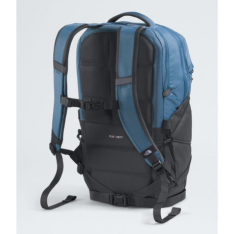 A technical backpack shown from the back, featuring a blue upper section and a black lower section with black straps and buckles, on a light gray background. - The North Face Borealis Backpack - Winslor Blue/Anthracite Grey/Utility Brown