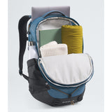 A Borealis backpack shown open, filled with a laptop, notebook, folded cream sweater, and a yellow rolled item, on a clean light gray studio background. - The North Face Borealis Backpack - Winslor Blue/Anthracite Grey/Utility Brown