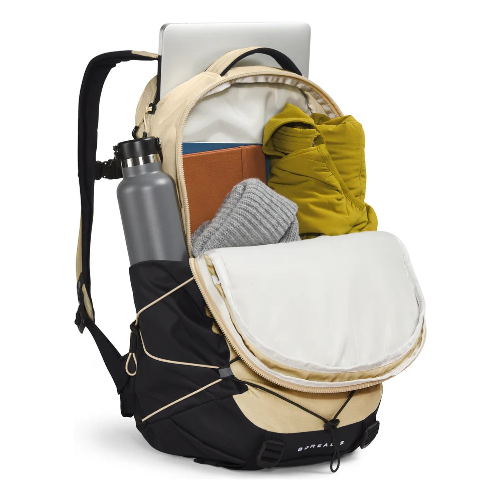 A beige and black backpack shown open with a laptop, water bottle, jacket, and folded items inside, photographed on a clean white background. - The North Face Borealis Backpack - Desert Stone/Stone Slab/Ember Soil