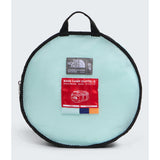 The North Face S/P Base Camp Duffel in a light mint green mesh zippered case with black trim, featuring a red and white branded hangtag. - The North Face Base Camp Duffel Small 50L - Canal Blue/Bold Blue/Papaya