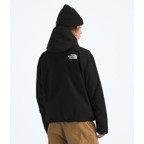 Person wearing a black hoodie with a logo on the back, standing against a white background - The North Face GORE-TEX Mountain Jacket (Men's) - TNF Black/TNF Black/TNF Black