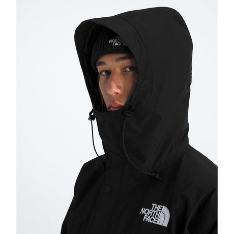 Person wearing a black The North Face jacket with hood on a white background - The North Face GORE-TEX Mountain Jacket (Men's) - TNF Black/TNF Black/TNF Black