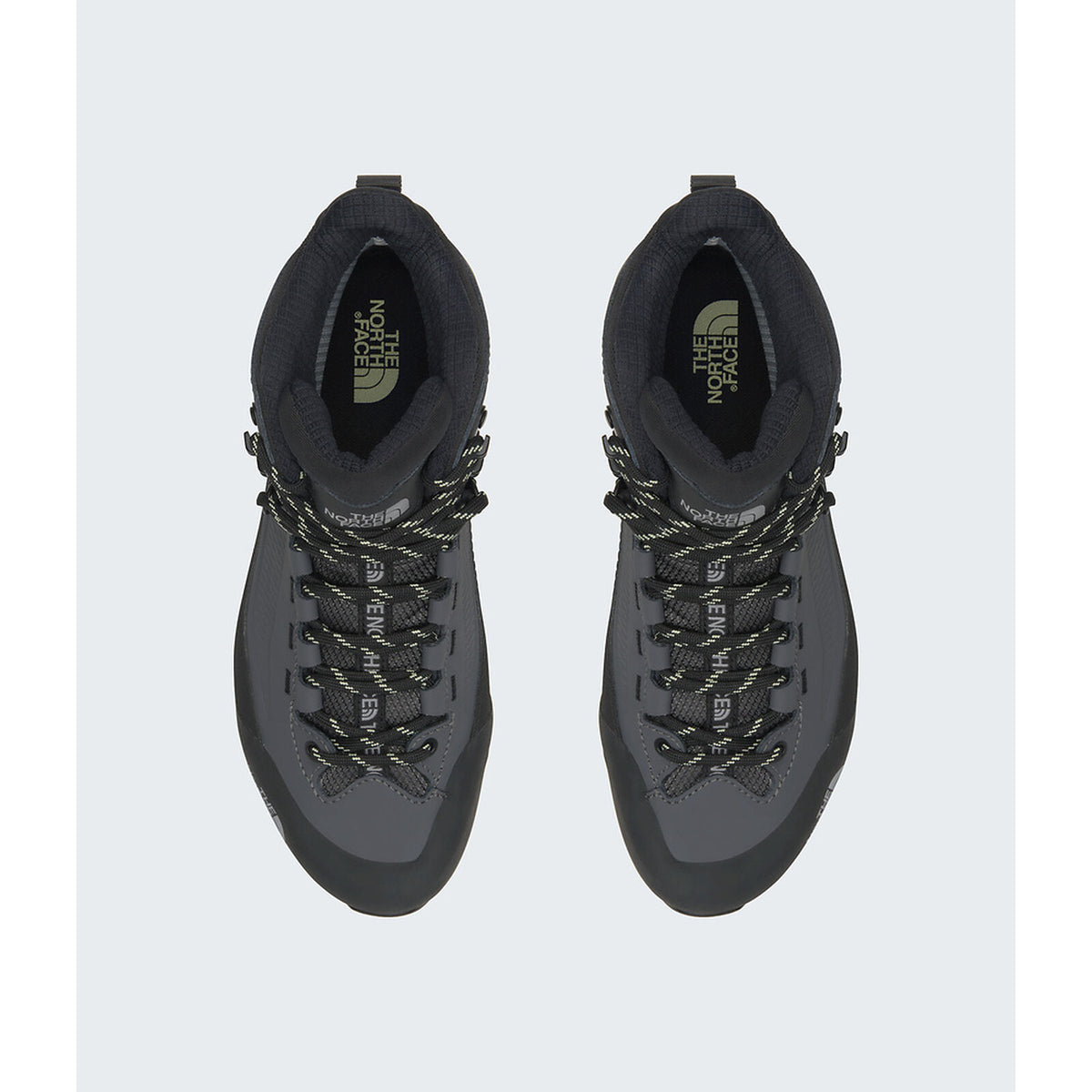 A pair of dark gray and black mid-cut hiking boots shown from a top-down view on a light gray background. The boots feature black laces with gray patterned detailing and the 'The North Face' logo is visible on the tongue. - The North Face Verto Alpine Mid GORE-TEX Boots (Women's) - Anthracite Grey/Lemon Mist