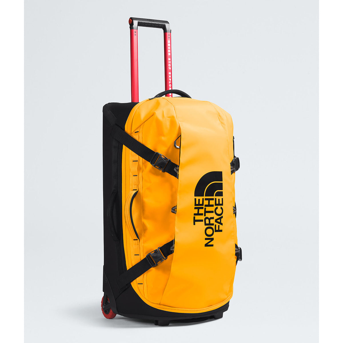 A bright yellow and black The North Face rolling duffel bag with an extended red telescoping handle, shown on a light gray background. - The North Face Base Camp Rolling Thunder 28" (95L) - Summit Gold/TNF Gold-NPF