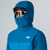 Person wearing a blue hooded jacket with a brand logo on a gray background - The North Face Jazzi 3L GORE-TEX Jacket (Men's) - Skyline Blue/Adriatic Blue