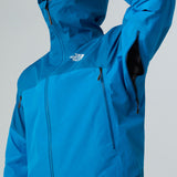 A close-up of a bright blue The North Face hooded jacket, showing the front zipper, chest zip pockets, and a white brand logo on the chest, set against a neutral gray background. - The North Face Jazzi 3L GORE-TEX Jacket (Men's) - Skyline Blue/Adriatic Blue