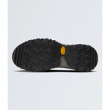 The bottom sole of a black Vibram hiking boot, showing a deep tread pattern and the signature yellow Vibram logo, set against a light gray background. - The North Face Hedgehog Mid GORE-TEX Boots (Women's) - TNF Black/Asphalt Grey