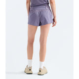 A person shown from the back wearing light purple athletic shorts, white socks, and beige running shoes against a plain light gray studio background. - The North Face Sunriser Shorts 3" (Women's) - Grounded Plum