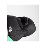 A close-up of a black sleeping bag with a white The North Face logo on the side, showing a mint green section at the bottom, set against a light gray background. - The North Face Inferno Sleeping Bag - 0F / -18C