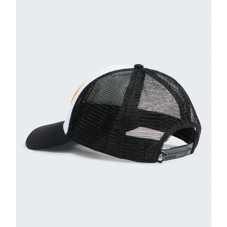 A black trucker-style cap with a white front panel and a small orange accent stripe, shown from a three-quarters angle against a light gray background. - The North Face Graphic Mudder Trucker - TNF White/TNF Black/TNF NSE Dome Patch