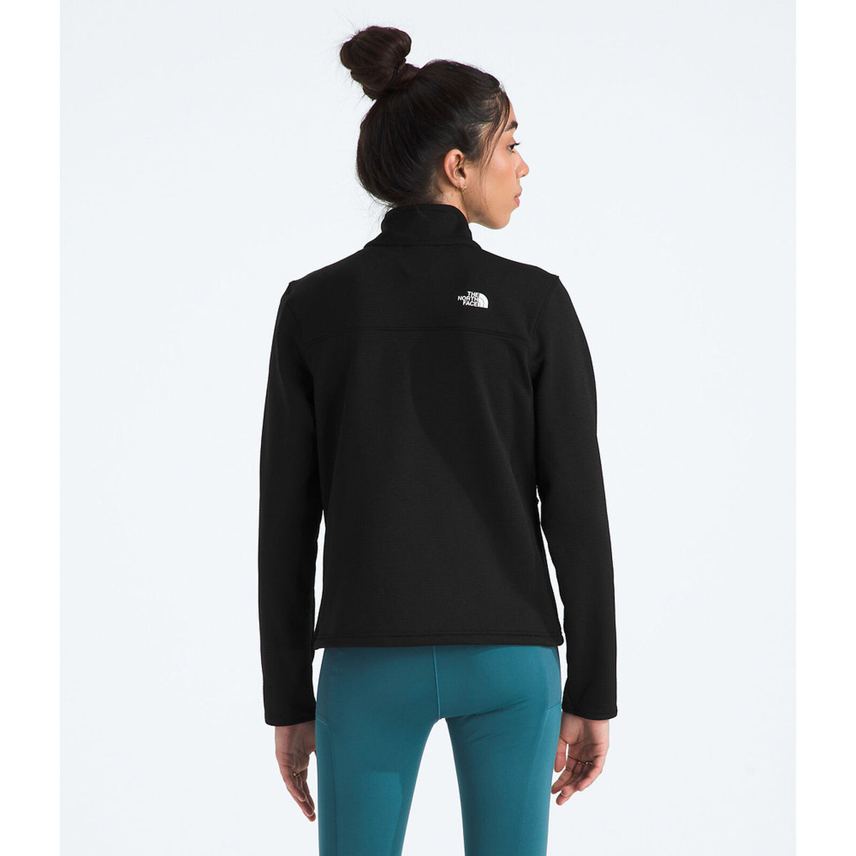Person wearing a black jacket with a logo on the back, standing against a white background - The North Face Cedar Trail Grid Fleece Jacket (Women's) - TNF Black